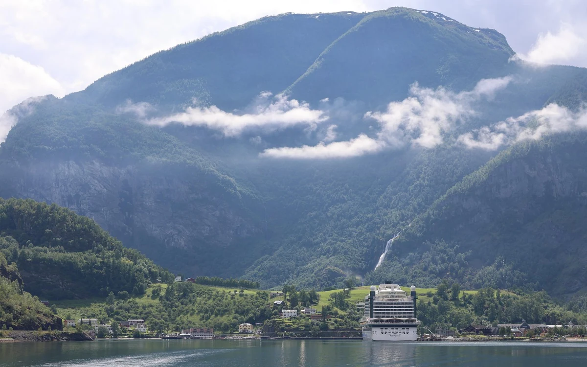 A Flåm Railway train on the mountain line above the village