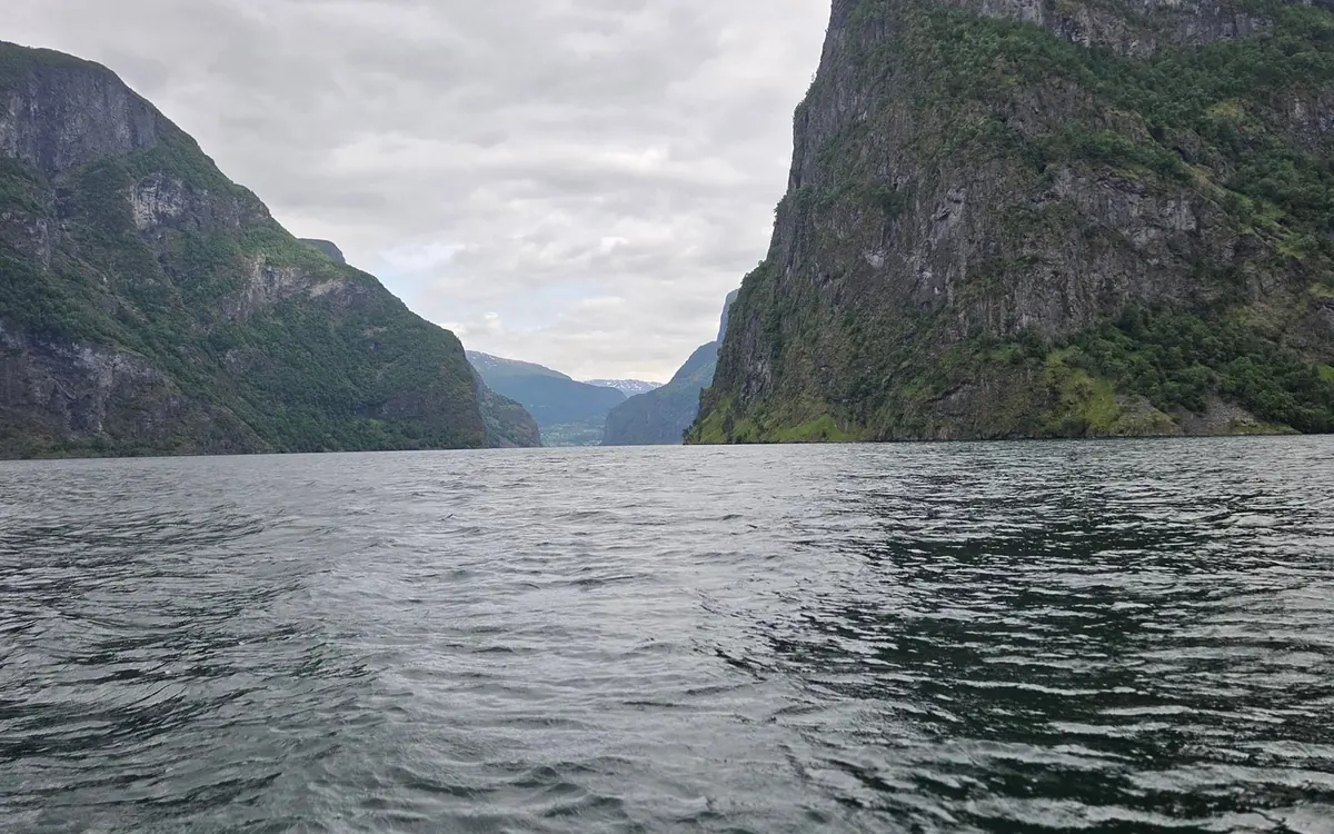 A RIB boat on the Nærøyfjord with steep mountain walls rising on both sides